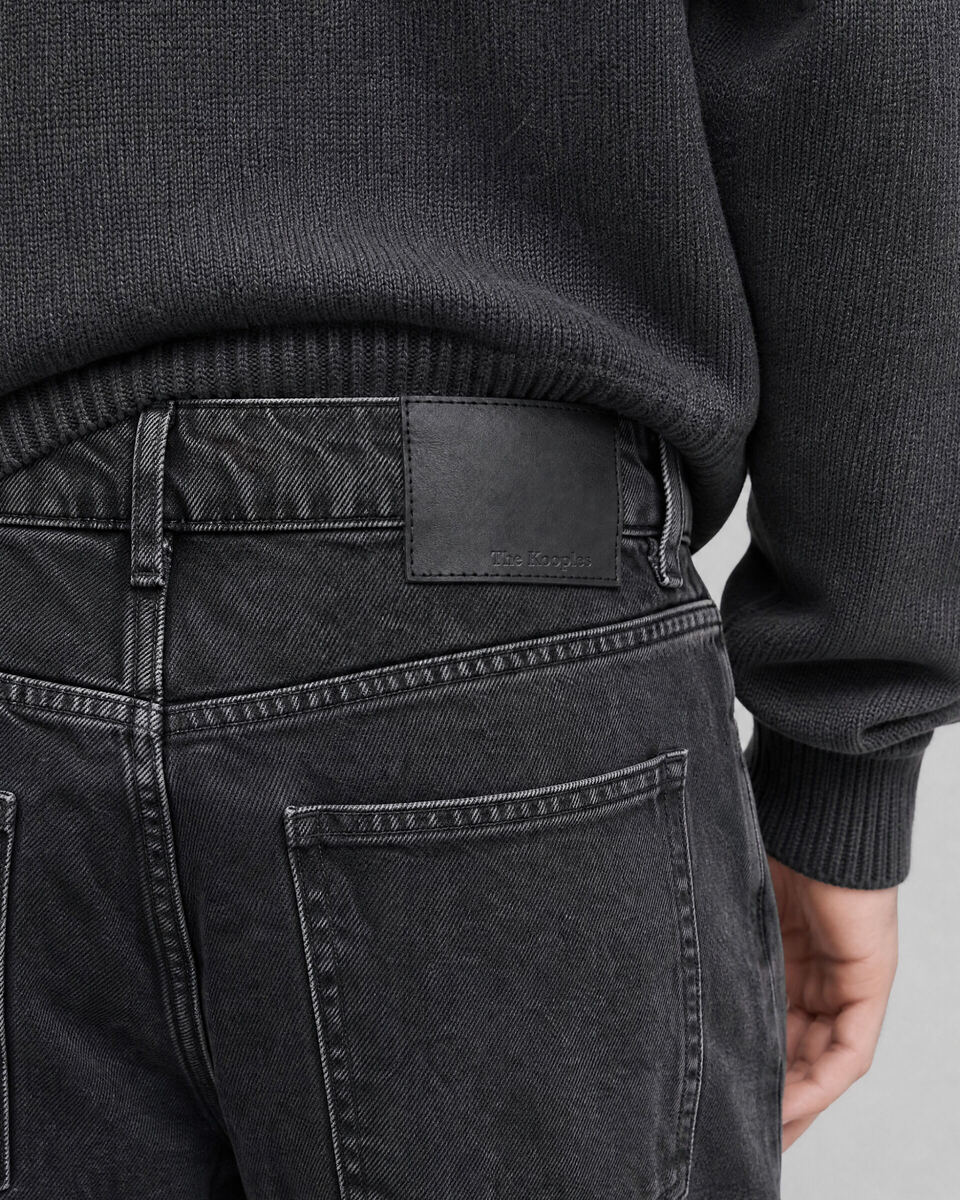 Black straight-leg jeans with a faded wash