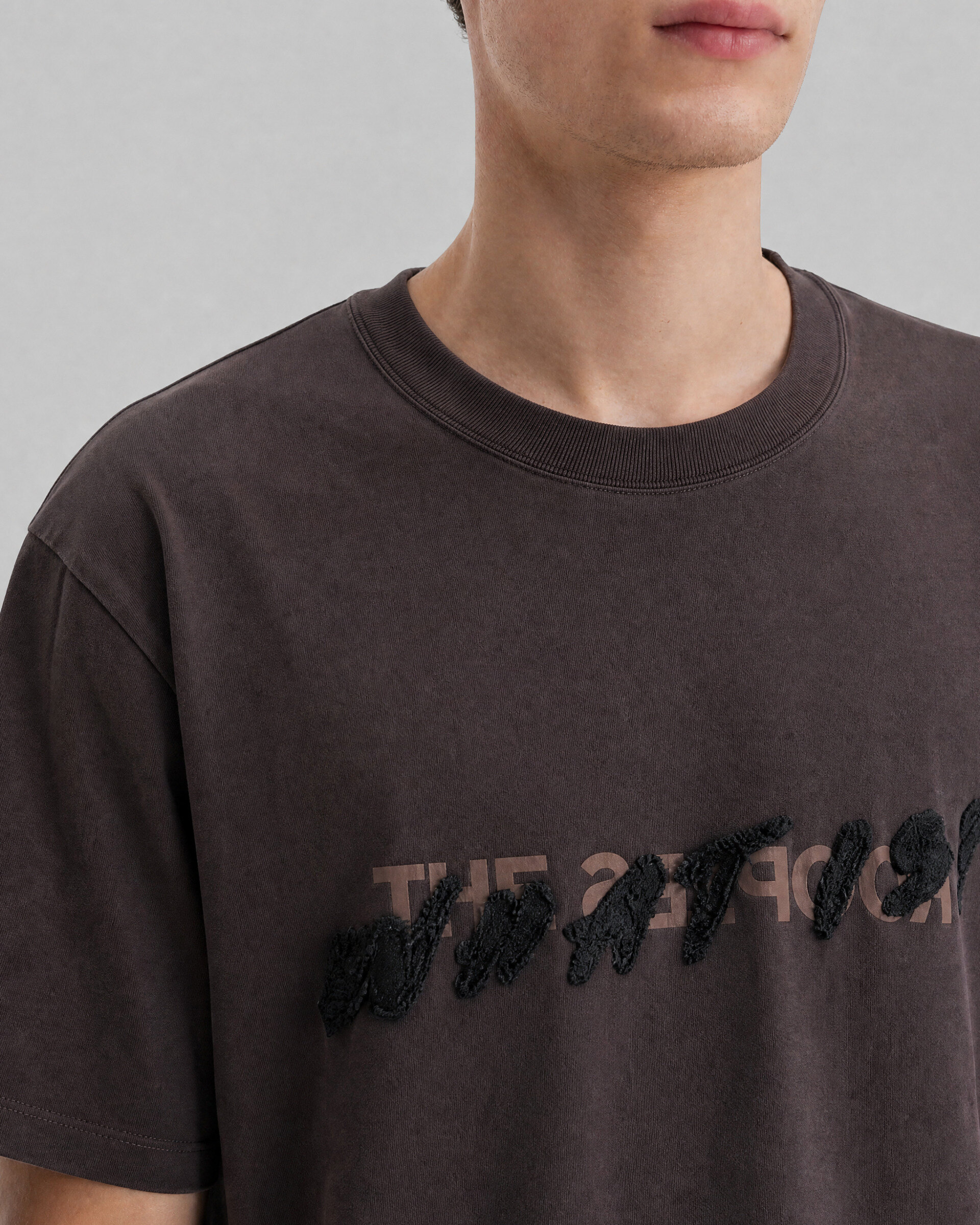 What is brown denim patch t-shirt