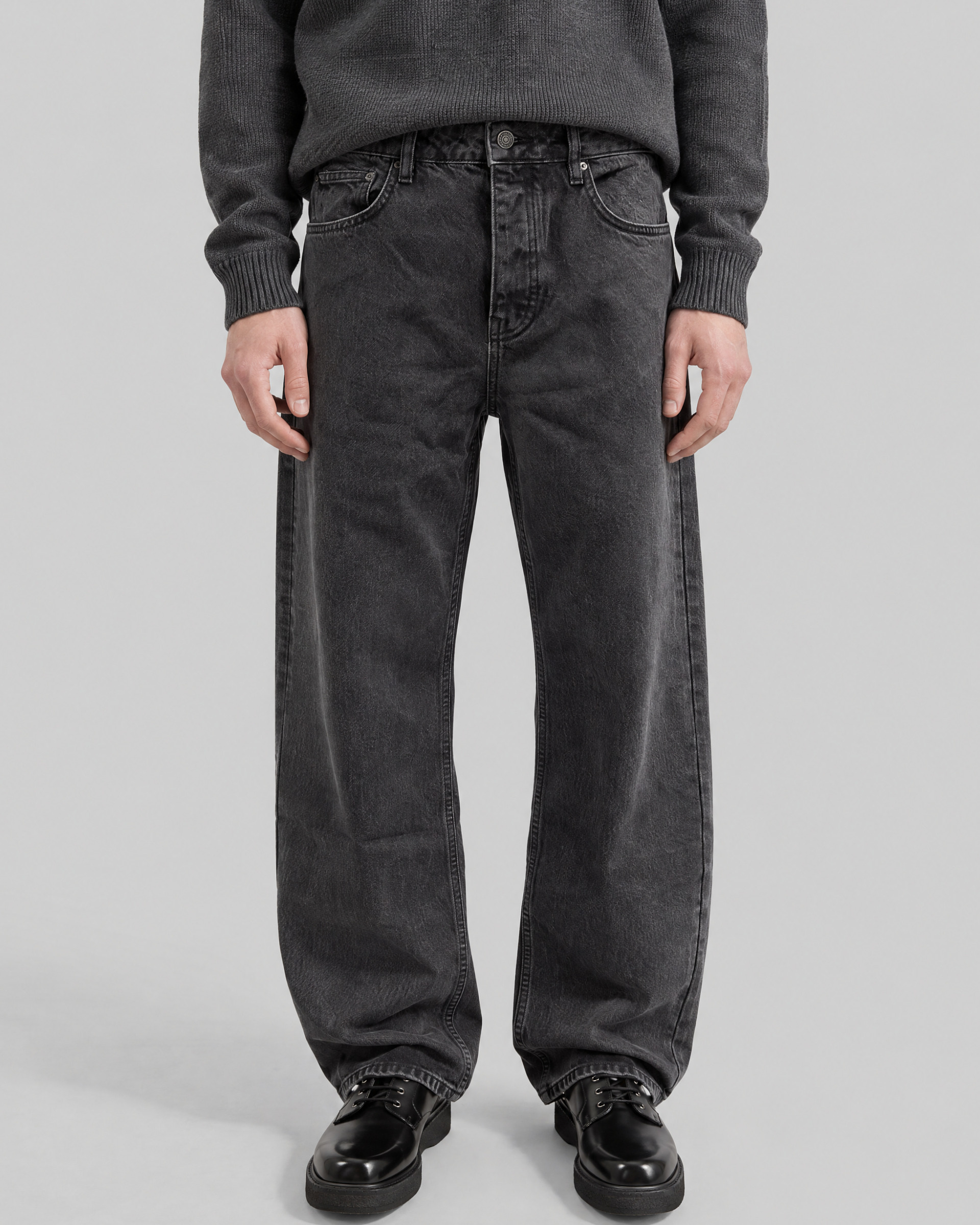 Black straight-leg jeans with a faded wash