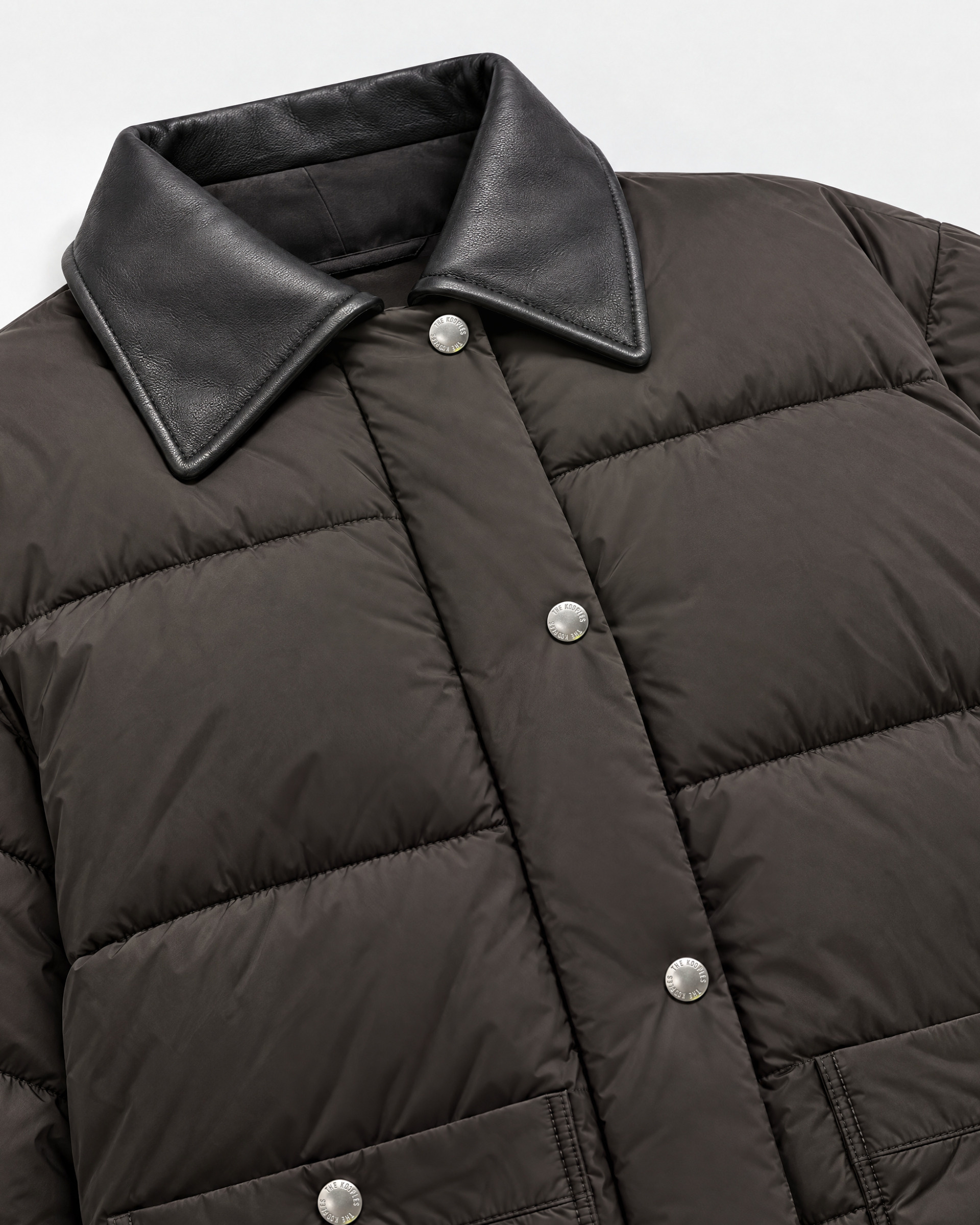 Oversized puffer jacket with brown leather collar