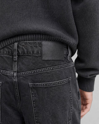 Black straight-leg jeans with a faded wash