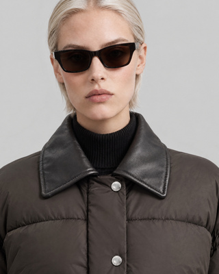Oversized puffer jacket with brown leather collar