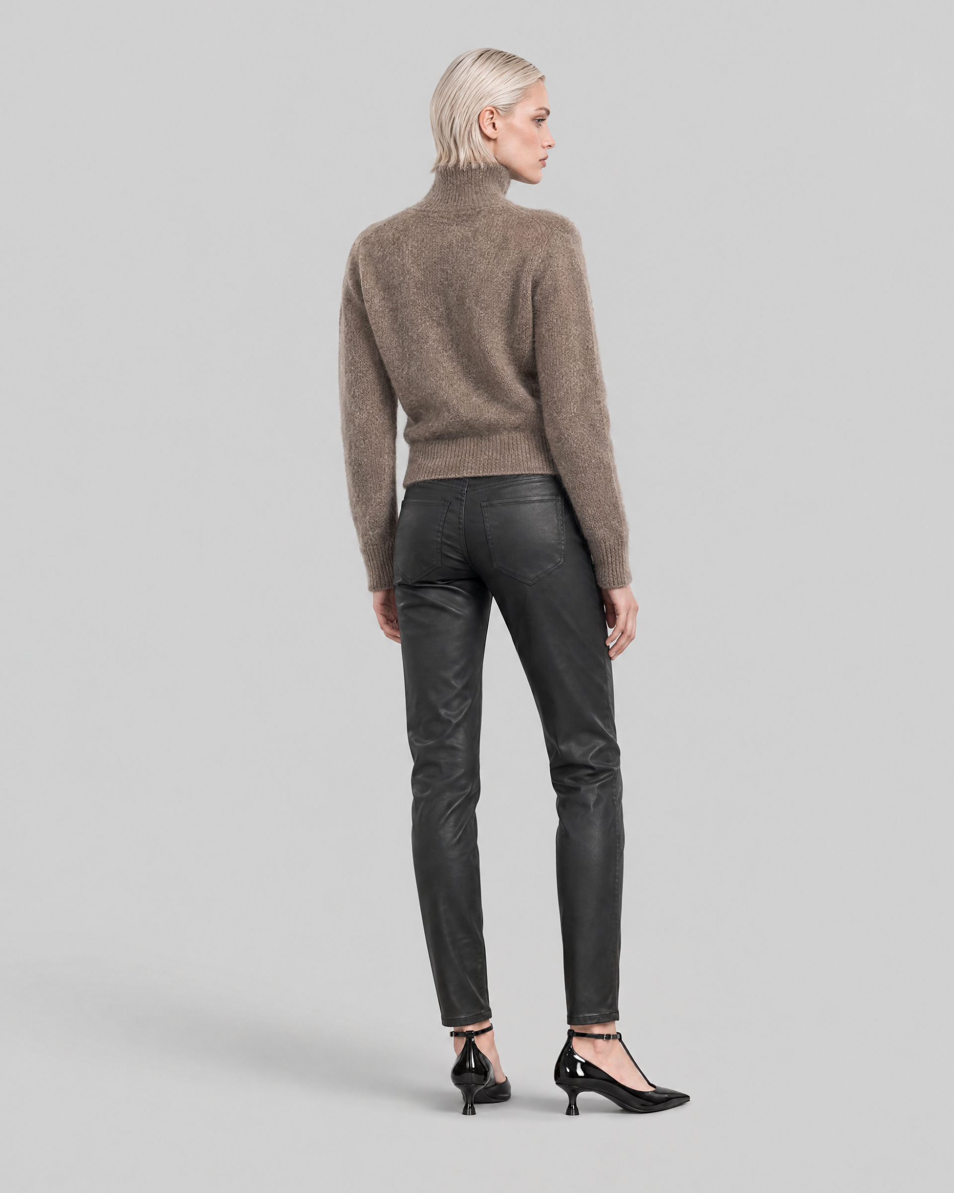 Black slim-fit jeans with a coated finish