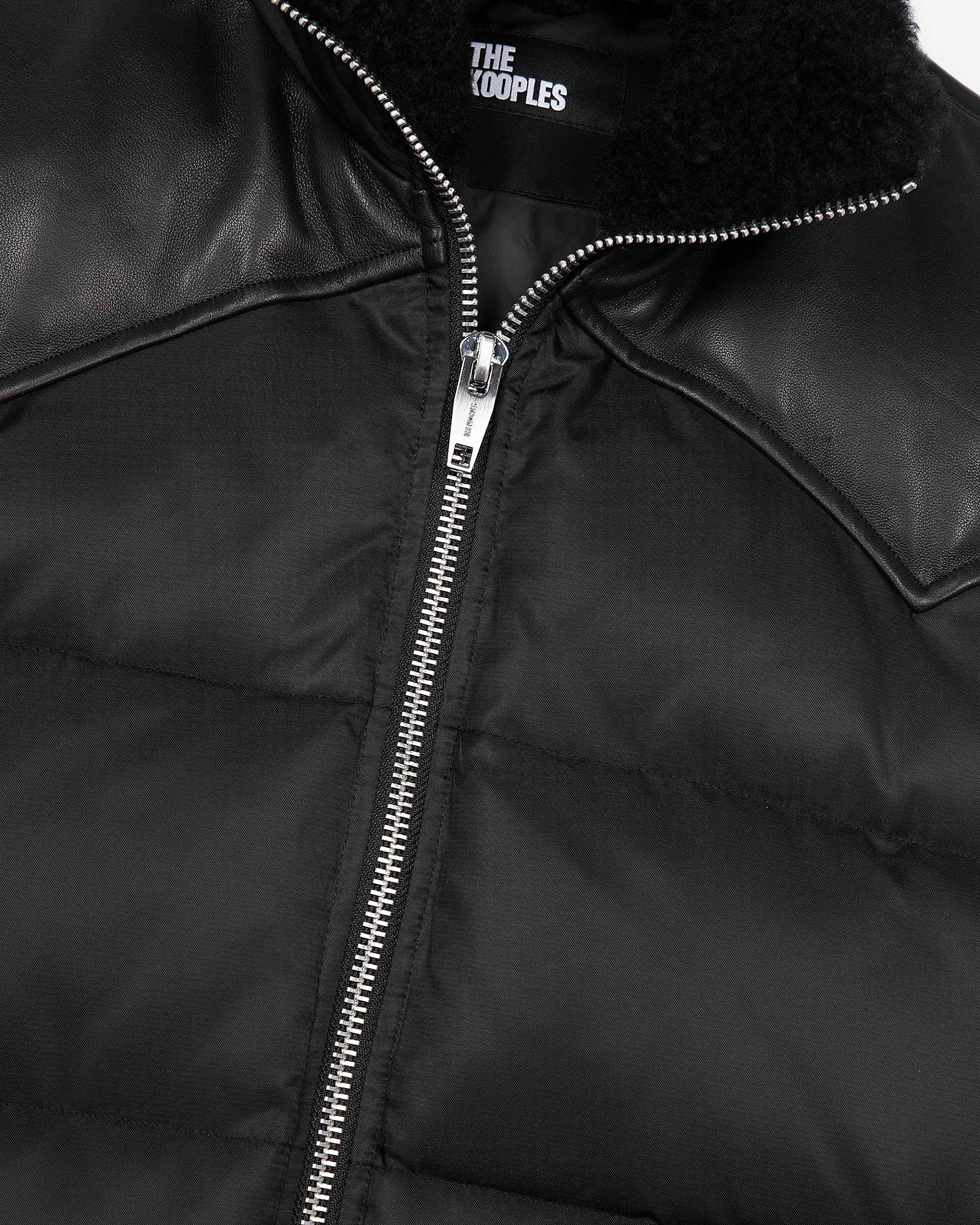 Sleeveless padded jacket with black fur collar