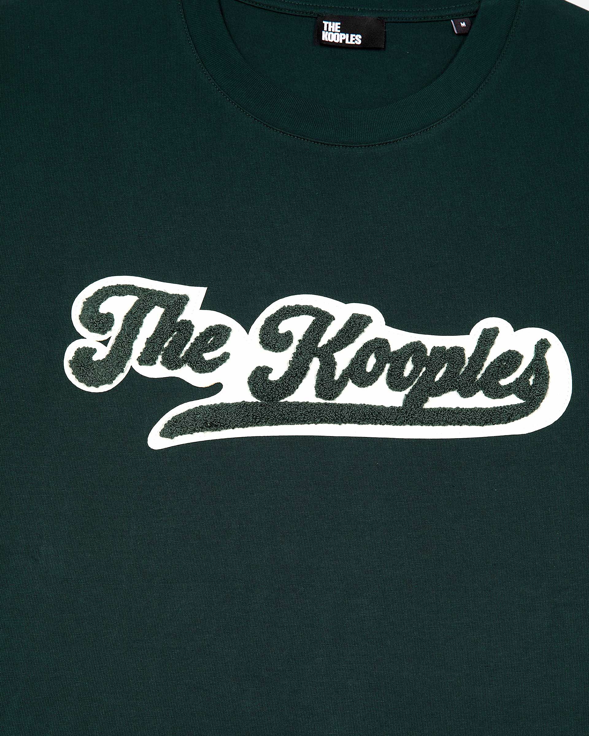 T-shirt with dark green patch