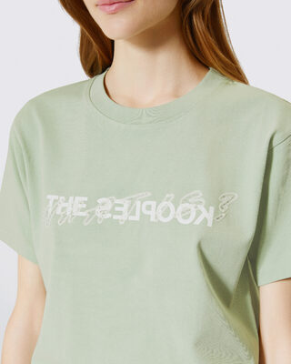 'What Is' T-shirt with green rhinestones